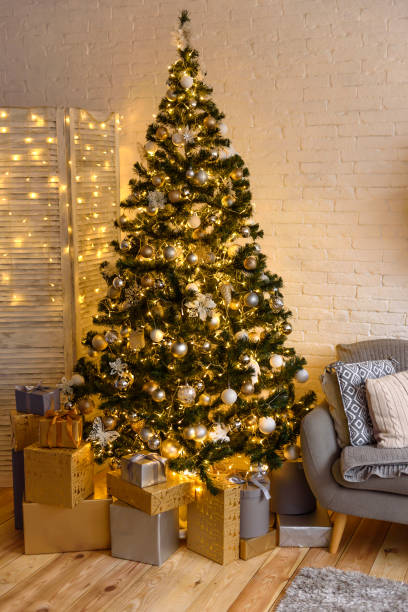 istock Beautiful holdiay decorated room with Christmas tree with presents under it 1290103235