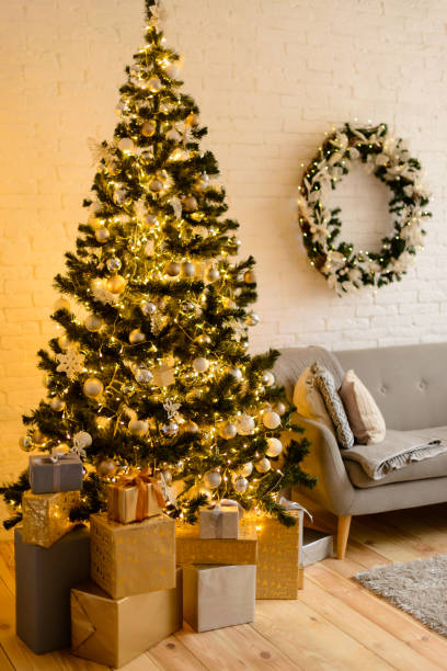 istock Beautiful holdiay decorated room with Christmas tree with presents under it 1290103455