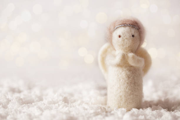 Christmas angel on lights bokeh background