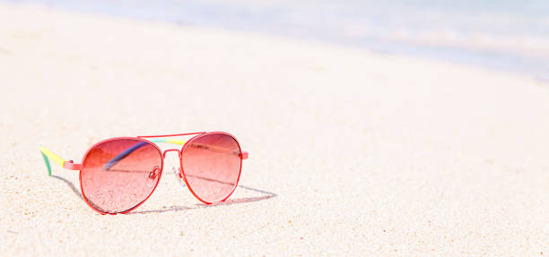 istock Red Sunglasses on the beach, tropical concept, banner 1290103720