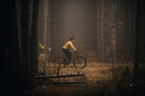 istock Young man biking through autumn forest 1290105246