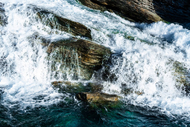 istock Wild and fast moving river rapids white water rushing over rugged cliffs. Close up. 1290105624