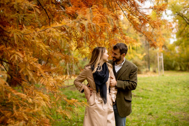 istock Young couple walking in the autumn park 1290106307