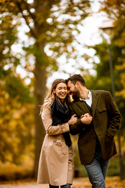 istock Young couple walking in the autumn park 1290106312