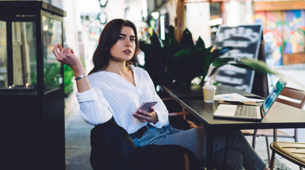 istock Thoughtful woman messaging on smartphone in cafe 1290106509