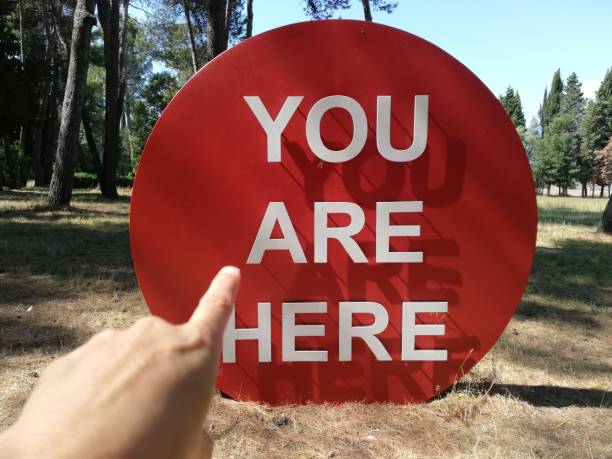 istock hand points to the red sign that says: you are here 1290106670
