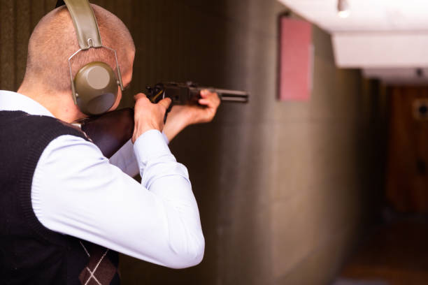 istock Man shoots a double-barreled gun at shooting range 1290109274