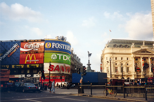 London, United Kingdom, March 1992. People visiting landmark billboards Piccadilly Circus, Rock City in Central London.