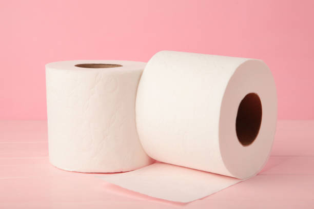 istock Toilet paper close-up on pink background with copy space 1290112483