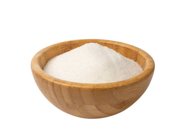 istock Small Crystals of White Sugar Isolated on White Background 1290113211