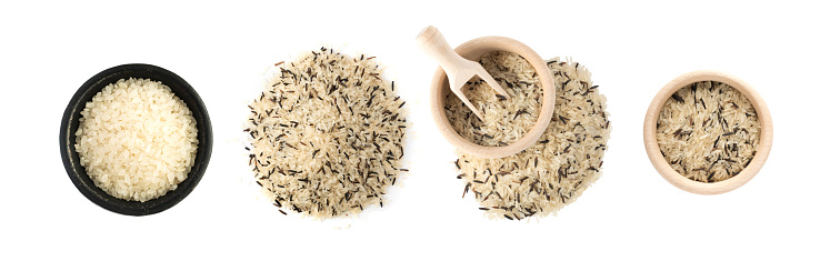 Top View Set of Raw Dry Black Wild Rice and Parboiled Long-Grain White Rice in Round Wood Bowls Isolated on White Background