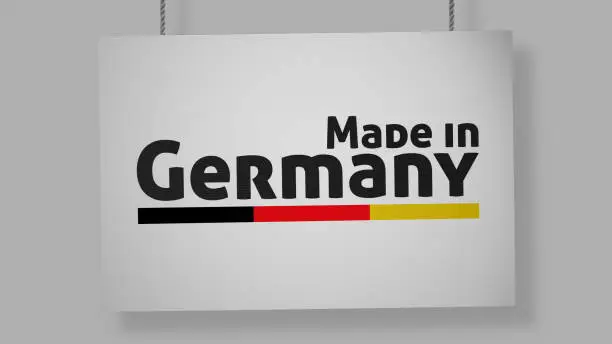 Photo of Made in Germany cardboard sign hanging from ropes. Clipping path included so you can put your own background.