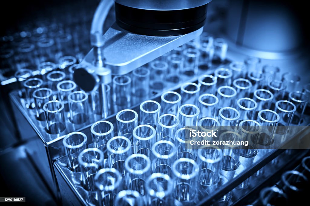 Analyzing Samples in Test Tube Backgrounds Analyzing samples in test tube backgrounds at laboratory. Laboratory Stock Photo