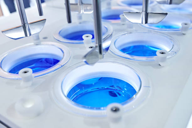 istock Automatic Stirring Blue Reagent in Group of Beakers 1290116549