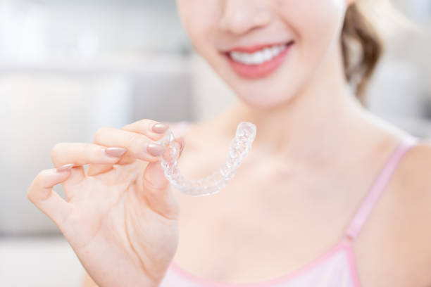 istock woman with retainer for teeth 1290117326