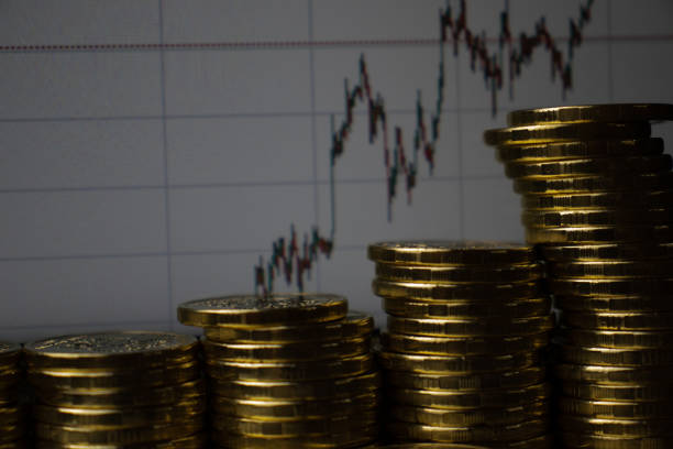 istock Stacks of gold coins on financial chart background. Exchange rate 1290118924