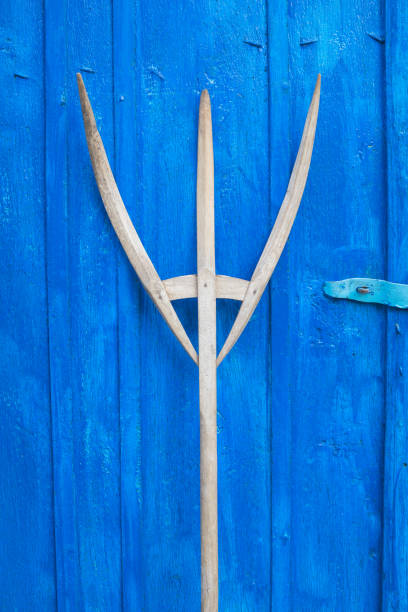 istock antique wooden pitchfork leaning on blue barn door 1290119504