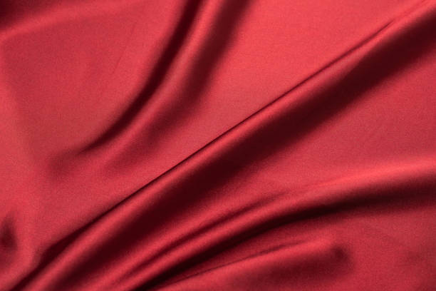 istock Red silk or satin luxury fabric texture. Top view 1290119772
