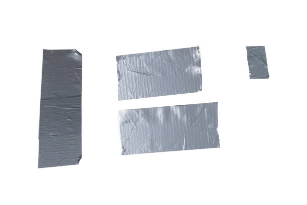istock Silver scotch tape pieces isolated on white background. 1290119805