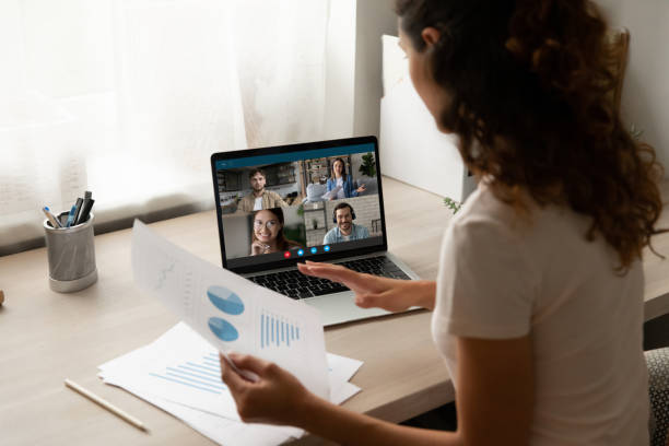 istock Rear view businesswoman holding documents, brainstorming statistics with colleagues 1290123069