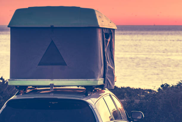 istock Car with roof top tent camp on beach 1290123181