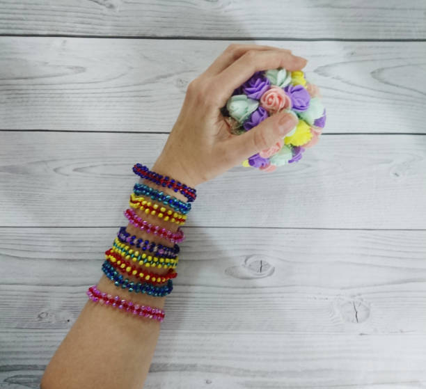 istock Female hand with bracelets on a light background 1290124201