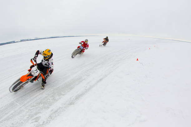 Leclaire, Iowa, USA - February 2, 2013: A person steers their motorcycle through a turn while practicing ice racing on a frozen river. Studded tires are used to maintain traction. Ice racing is a popular sport in colder climates where rivers and lakes freeze over in the winter months.