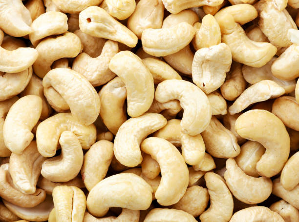 istock Cashew kernel closeup background. View of the top. 1290128450