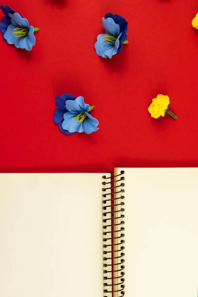 istock Flowers vertical composition, flat design, blank notebook with place for text on a red background, top view 1290129909