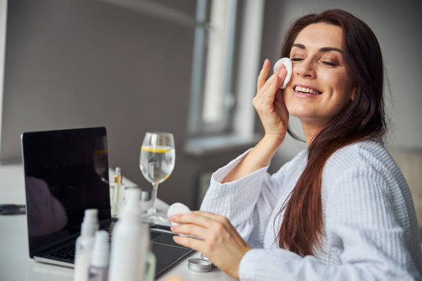 istock Amazing brunette female preparing skin for makeup 1290130271