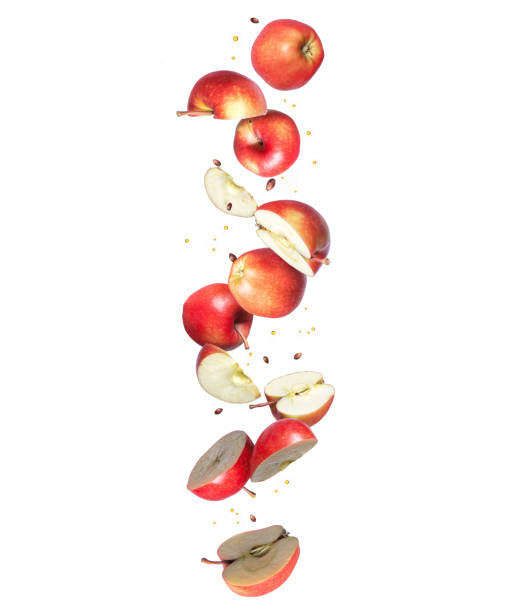 istock Chopped ripe apples are falling down, isolated on a white background 1290131386