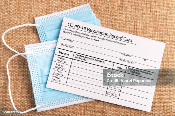 Coronavirus Vaccination Record Card Protective Mask Divided Into Two Parts Concept Of Defeating Covid19 Stock Photo - Download Image Now