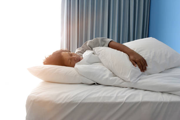 istock man sleeping on bed in hotel bedroom 1290132229