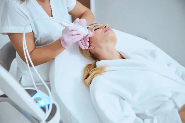 Photo of Blonde woman getting a skin tightening treatment