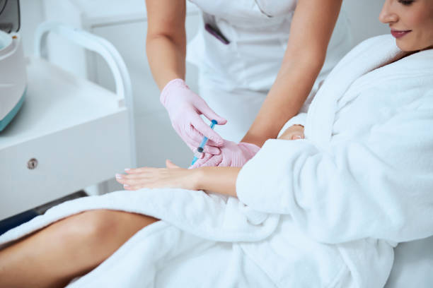 istock Woman client undergoing the hand rejuvenation procedure 1290133609