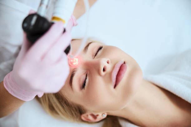 istock Young Caucasian woman being treated for forehead wrinkles 1290133621