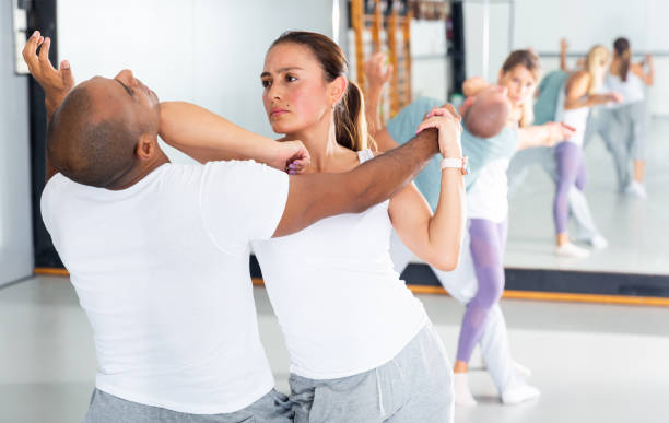 istock Woman and her trainer are training captures on the self-defense course 1290133707