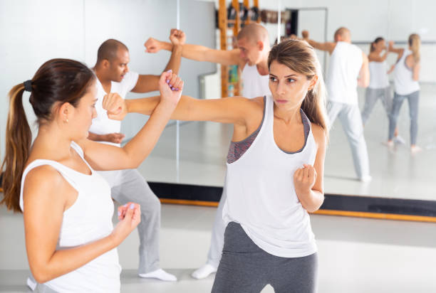 istock Two woman is training on self defense course in gym 1290133745