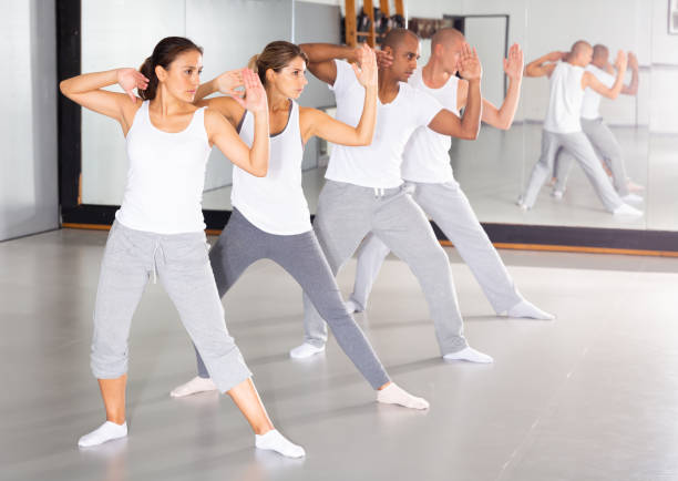 istock Men and women mastering self-defense techniques in training room 1290133752