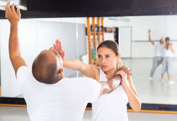 istock Woman and her trainer are training captures on the self-defense course 1290133763