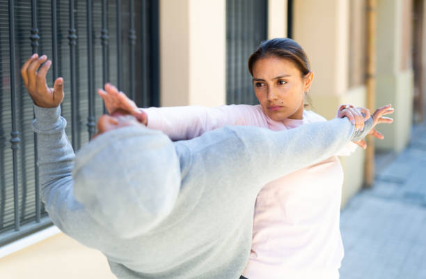 istock Woman defends herself from robber attack on street 1290133764