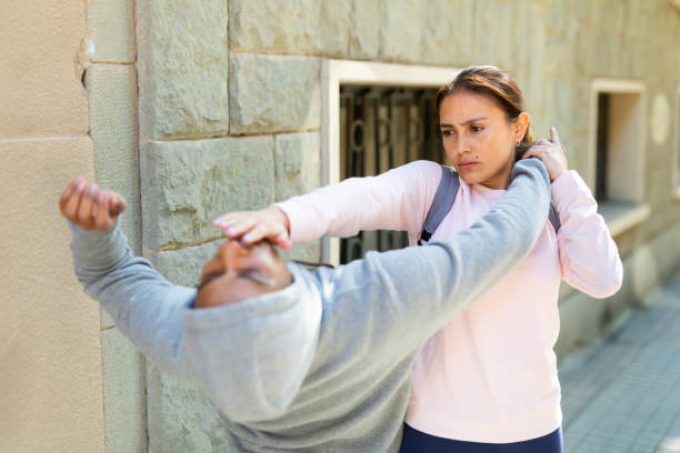 istock Woman defends herself from robber attack on street 1290133773