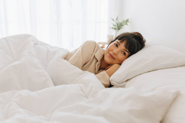 istock Woman lying on bed at home 1290133883