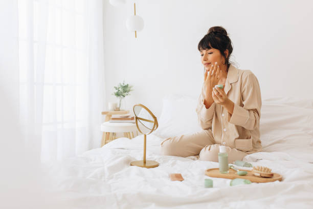 istock Young woman applying face cream 1290133886