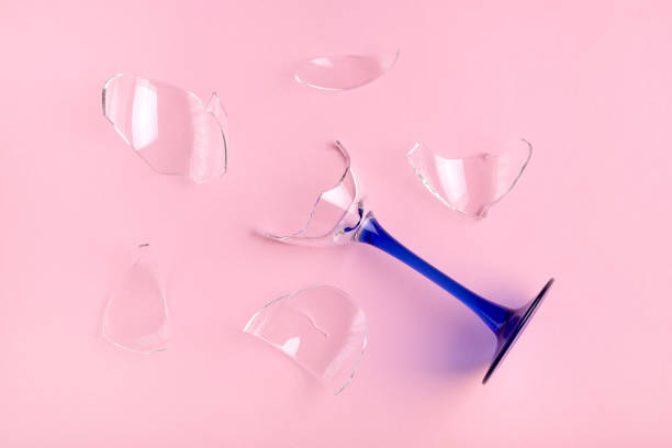 istock Broken glass wine goblet with blue leg on pink background. 1290134915
