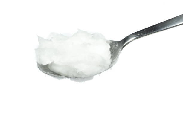 istock Coconut oil on spoon isolated on white background 1290141836