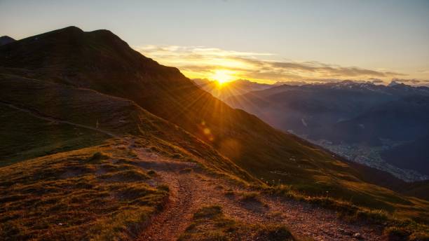 mountain hiking trail in the sunrise. Adventurous bike trail, hiking trail in mountains above Davos Switzerland Trail sunrise point stock pictures, royalty-free photos & images