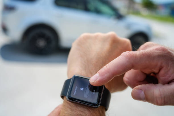 istock Male hands using smartwatch to lock / unlock car 1290148267