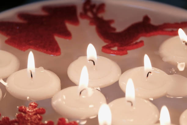 Felt Christmas Ornaments and Floating Candles on Water stock photo