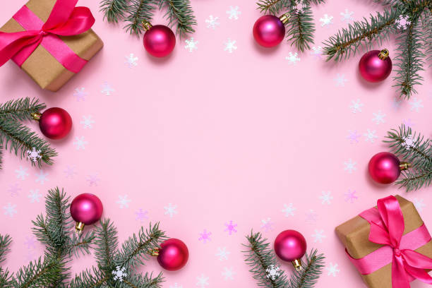 istock Christmas decorations and fir tree on pink background 1290152700